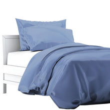 a bed made with mineral blue terrera duvet cover and two pillowcases on white background