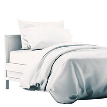 a bed made with white terrera duvet cover and two pillowcases on white background