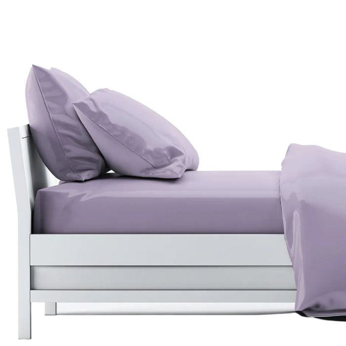 bed made with amethyst purple sheet set, flat sheet, fitted sheet and two pillowcases on white background