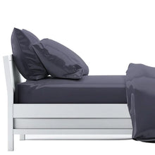 bed made with charcoal grey sheet set, flat sheet, fitted sheet and two pillowcases on white background