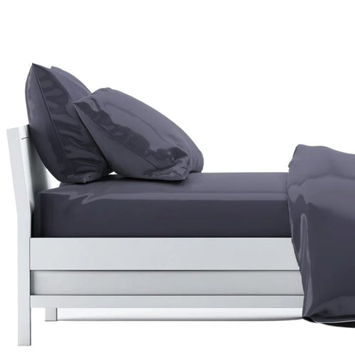 bed made with charcoal grey sheet set, flat sheet, fitted sheet and two pillowcases on white background