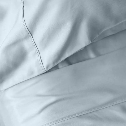 bed made with ice blue sheet set, flat sheet, fitted sheet and pillowcase