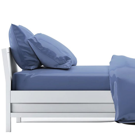 bed made with mineral blue sheet set, flat sheet, fitted sheet and two pillowcases on white background