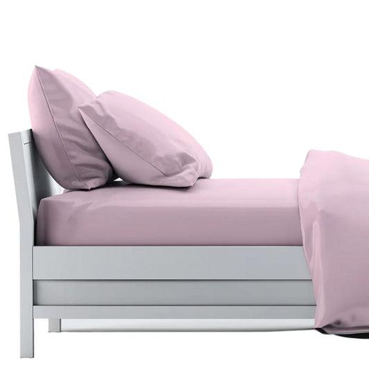 bed made with pale rose pink sheet set, flat sheet, fitted sheet and two pillowcases on white background