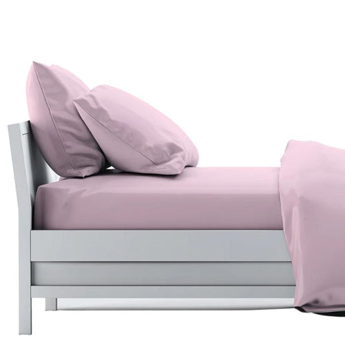 bed made with pale rose pink sheet set, flat sheet, fitted sheet and two pillowcases on white background