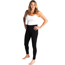 female model wearing black terry leggings and white essential cami front view on white background