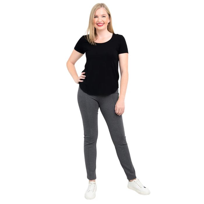 female model wearing black tessa tee and granite grey nadia pants front view on white background 