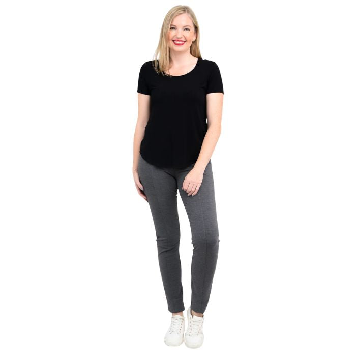 female model wearing black tessa tee and granite grey nadia pants front view on white background