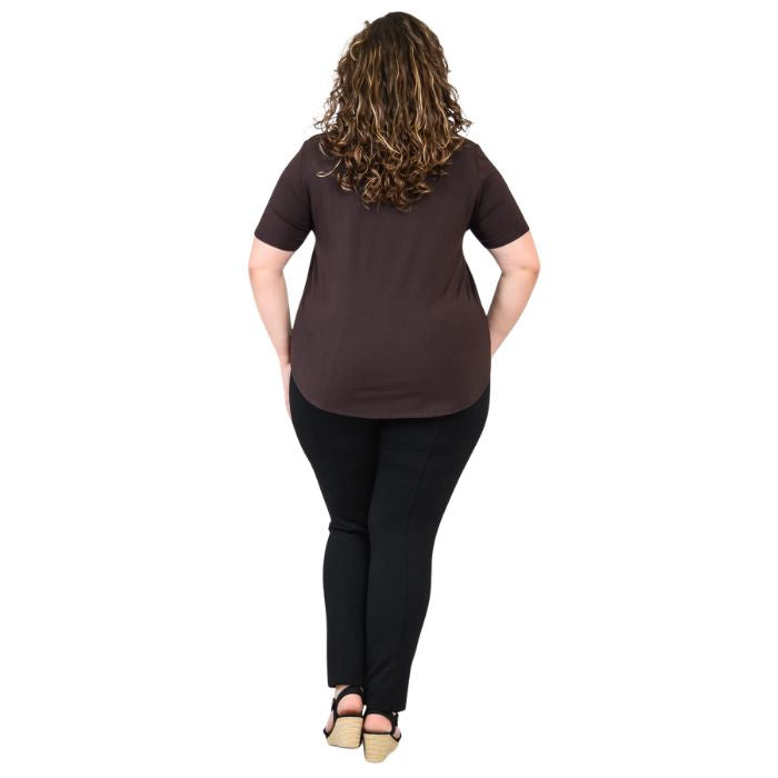 female model wearing coffee brown tessa tee and black nadia pants back view on white background