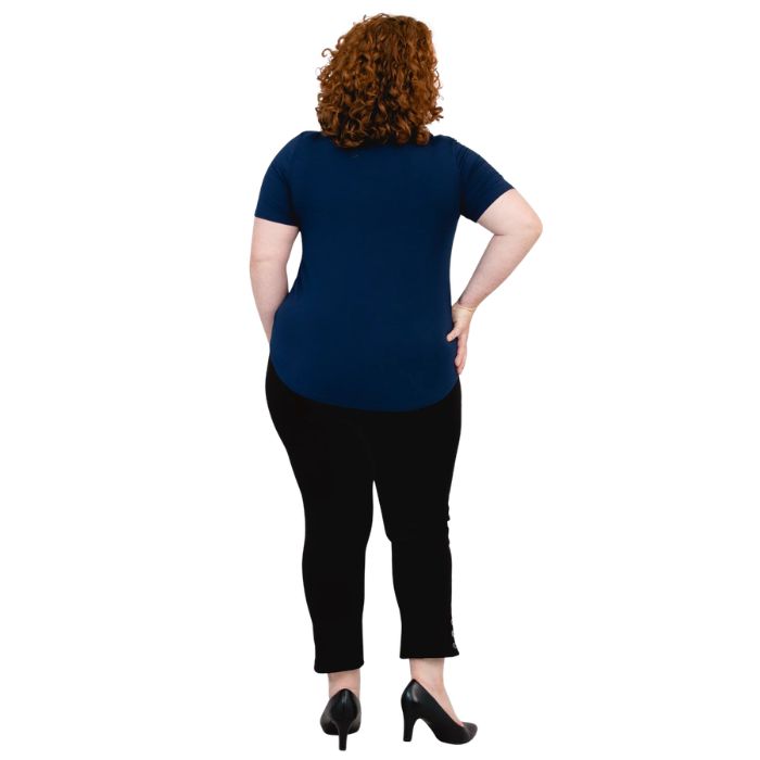 female model wearing indigo blue tessa tee and black nadine cropped pants back view on white background