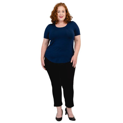 female model wearing indigo blue tessa tee and black nadine cropped pants front view on white background