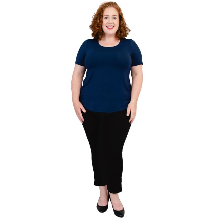 female model wearing indigo blue tessa tee and black nadine cropped pants front view on white background