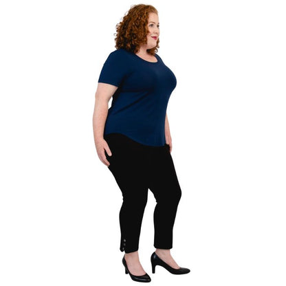 female model wearing indigo blue tessa tee and black nadine cropped pants side view on white background