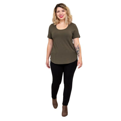 female model wearing khaki green tessa tee and black nadia pants front view on white background