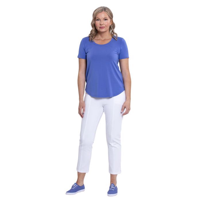 female model wearing periwinkle blue tessa tee and white nadine cropped pants front view on white background