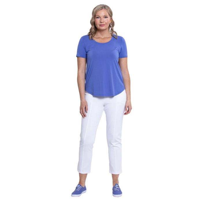 female model wearing periwinkle blue tessa tee and white nadine cropped pants front view on white background