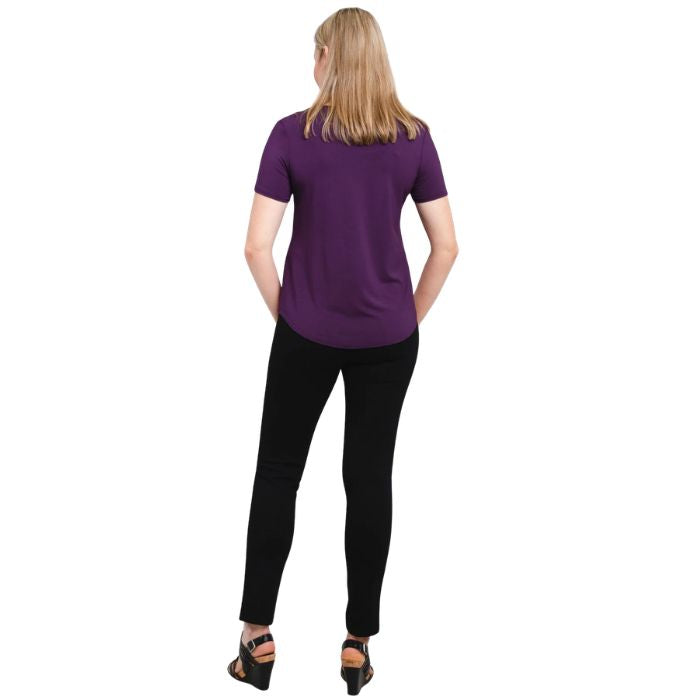 female model wearing royale purple tessa tee and black nadia pants back view on white background