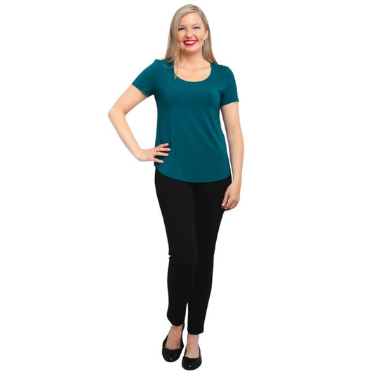 female model wearing teal green tessa tee and black nadia pants front view on white background