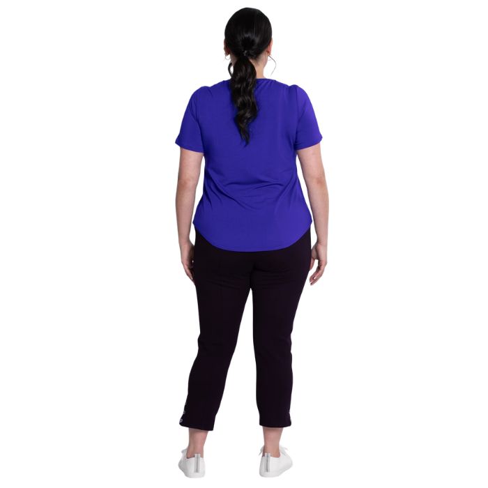 female model wearing violet purple tessa tee and black nadine cropped pants back view on white background