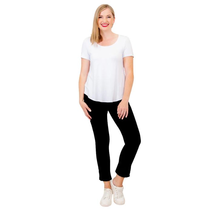 female model wearing white tessa tee and black nadia cropped pants front view on white background