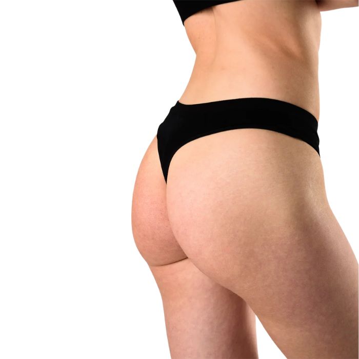 female model wearing black thong underwear back view on white background