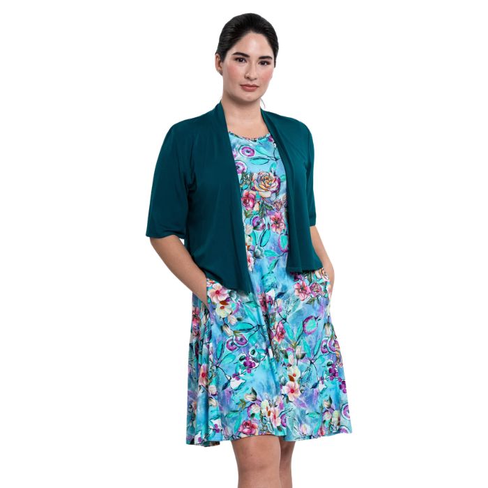 female model wearing teal nectar print willow dress and teal green doda jacket front veiw on white background