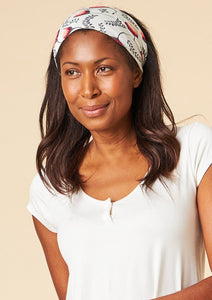 This Is J's Wide Headbands reverse from a unique print to a solid color. The fabric is ultra-soft and moisture-wicking and is soft enough to scrunch and fold into different widths. It comes twisted in the back for a comfortable tapered fit.  Made in Canada  Fabrication: 93% Viscose from Bamboo / 7% Spandex. $16.00 off white floating venus flower