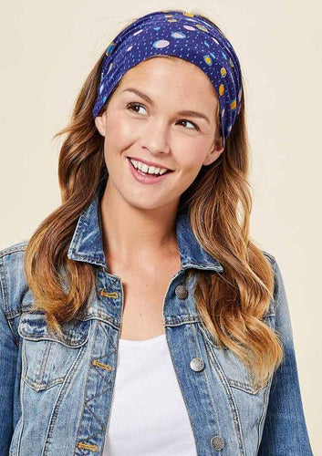 This Is J's Wide Headbands reverse from a unique print to a solid color. The fabric is ultra-soft and moisture-wicking and is soft enough to scrunch and fold into different widths. It comes twisted in the back for a comfortable tapered fit.  Made in Canada  Fabrication: 93% Viscose from Bamboo / 7% Spandex. $16.00 violet purple raining circles
