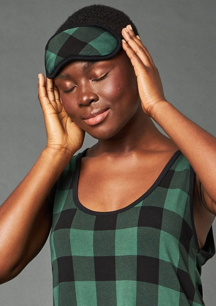 The Carly Sleep Mask filter out lights and other disturbances so that you can get the rest you need. Made from This Is J's ultra-soft and hand-printed fabric. Fits comfortably on all head sizes with a soft scrunch elastic band that goes around the back of the head.  Made in Canada.  Fabrication: 93% Viscose from Bamboo 7% Spandex. $35.00 green plaid