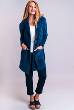  A beautiful long jacket in Blue Sky's cotton velvet. Patch pockets, large hood and mixed-but-matched buttons are casual, but the shawl collar has a tailored touch.  This specific blue that suits every skin tone.  Fabrication: 50% Bamboo, 50% Cotton  BLUE SKY Colour Blue $95.00