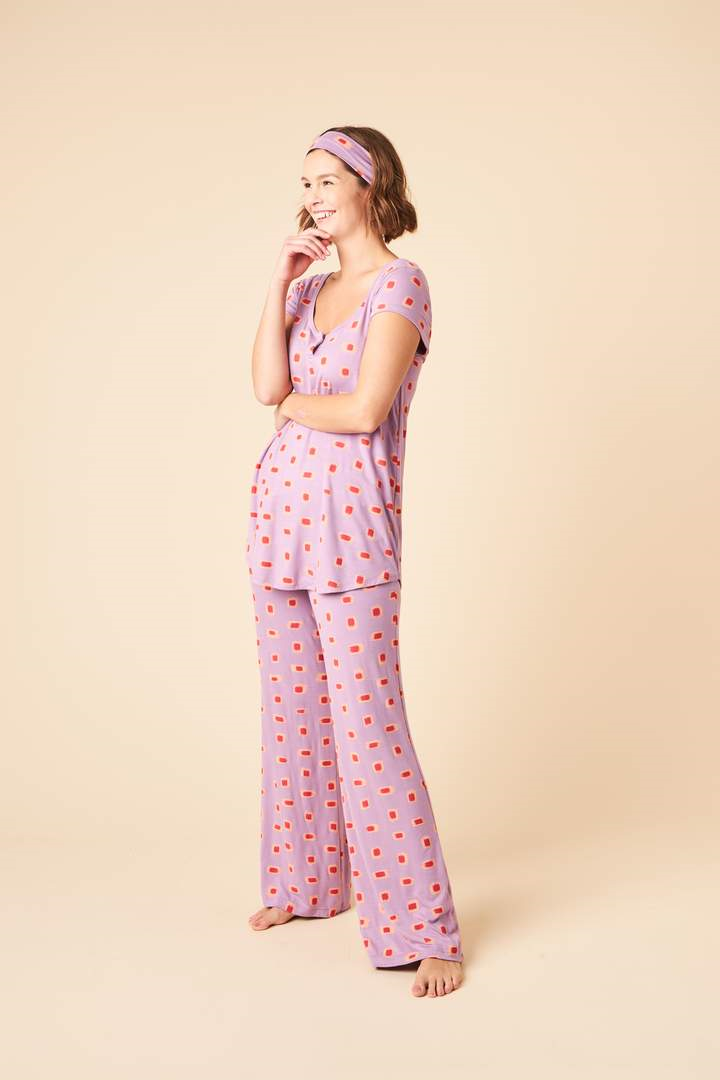 Softly draped fabric, thoughtful detail, and a flattering fit makes the Debbie Short Sleeve Set the perfect style to transition you from lounging to sleeping. This set includes a flowy cap sleeve top with keyhole detail that can be buttoned closed, long pants with a wide stretchy drawstring waistband, and a matching headband.  Proudly Made in Canada Fabrication: 93% Bamboo Viscose 7% Spandex This is J $148.00 Colour Purple Ikat Marks