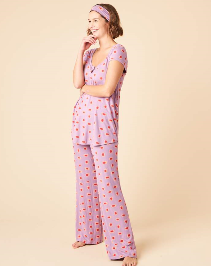 Softly draped fabric, thoughtful detail, and a flattering fit makes the Debbie Short Sleeve Set the perfect style to transition you from lounging to sleeping. This set includes a flowy cap sleeve top with keyhole detail that can be buttoned closed, long pants with a wide stretchy drawstring waistband, and a matching headband.  Proudly Made in Canada Fabrication: 93% Bamboo Viscose 7% Spandex, This is J-Colour Ikat Marks Purple $148.00
