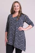 You will love the Winnie Tunic it is all things to all body shapes. A stylish asymmetrical neckline and hemline lengthen, for a slender tunic effect that doesn't cut across the body. Double-layered fabric in the bodice adds a sense of structure, and provides extra coverage.  Fabrication: 95% Bamboo, 5% Lycra  BLUE SKY $75.00 colour triumph pattern sharkskin grey
