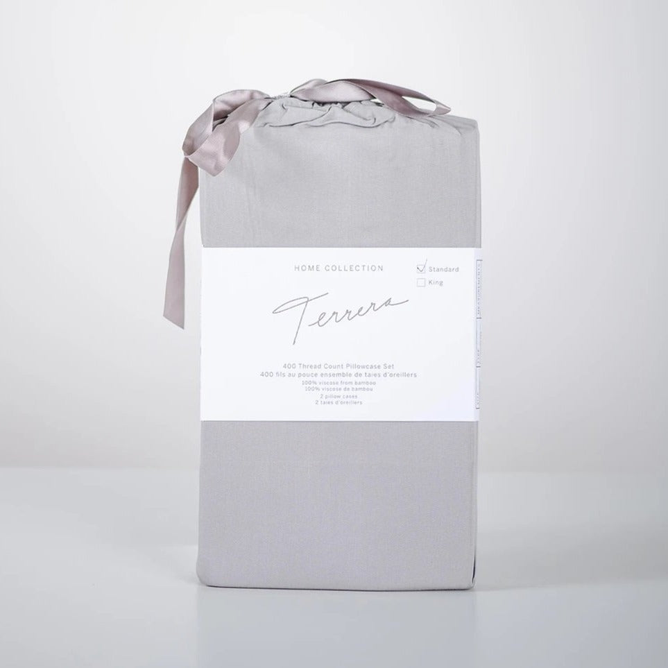 Lay your head on the ultra-soft Terrera Bamboo Pillowcase. Made with their signature eco-friendly bamboo viscose, which is naturally thermo-regulating and breathable - an excellent option for those with sensitive skin. The 400 Thread count guarantees you'll wake up feeling refreshed. (2/Set) Fabrication: 100% Certified Organic Viscose from Bamboo TERRERA Grey $30/$33