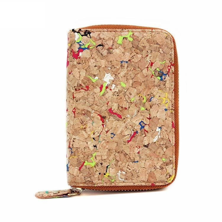 The Ladies Speckled Cork Wallet is crafted from sustainable multi colored cork. It features a sleek zip-around design that opens to reveal a well-organized interior. This petite yet practical vegan wallet offers plenty of card slots, a few compartments and a snap-shut coin pocket for loose change. Will also fit most cell phones!  KUMA $44.00 colour Natural
