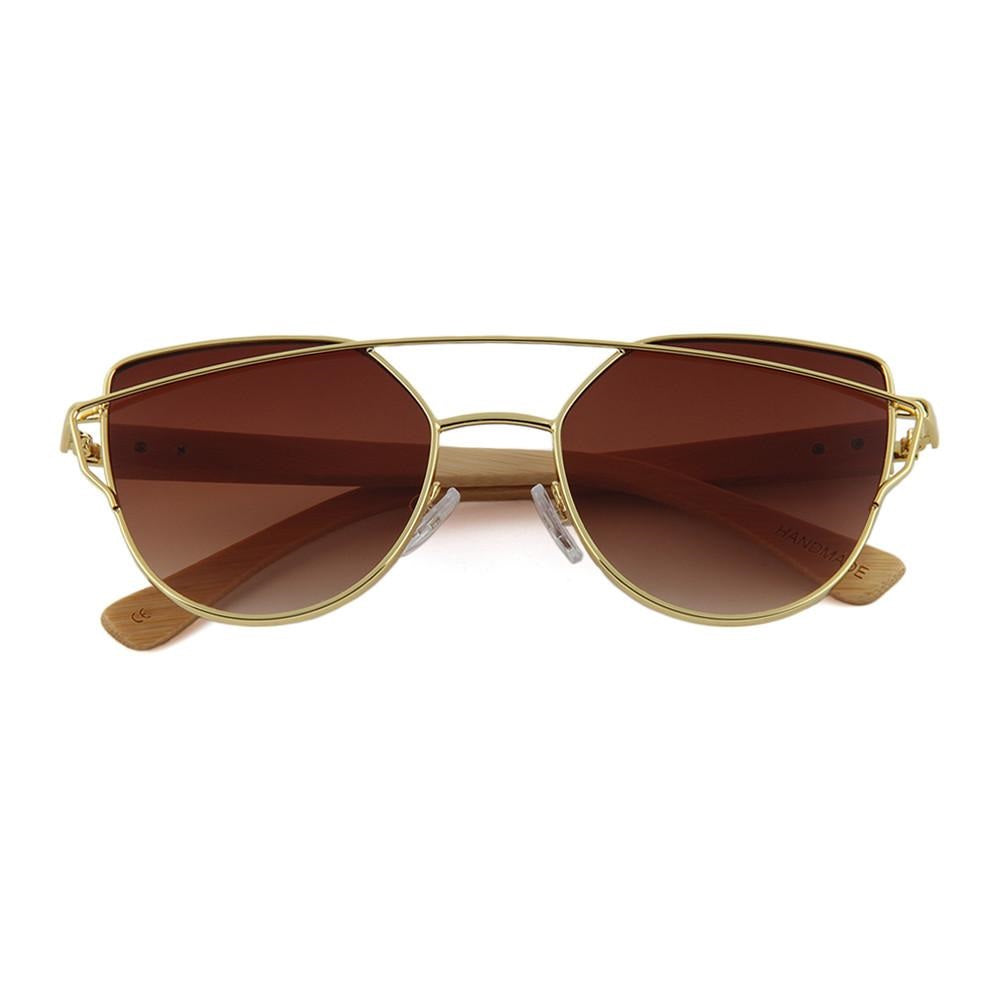 Inspired by the flat leaves and delicate but strong branches of the Olive tree the timeless design of our Olive Sunglasses with its delicate lines and flat mirrored lens hearkens back to an earlier time all while embodying fashion forward design and natural elements!  KUMA Plants a Tree for Every Pair Sold! 100% UVA/UVB protection Handcrafted Natural Bamboo Temples KUMA $35.00 Tan