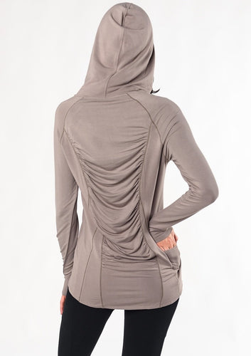 Move freely in this pull-on tunic hoodie. Designed with flattering front-seam details, cascading ruching in the back, and a longer length for hip and bum coverage. Make a match with the Ruched Movement Legging. Fabrication: 95% Viscose from Bamboo 5% Spandex $110.00 taupe brown