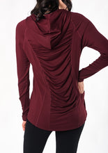 Move freely in this pull-on tunic hoodie. Designed with flattering front-seam details, cascading ruching in the back, and a longer length for hip and bum coverage. Make a match with the Ruched Movement Legging. Fabrication: 95% Viscose from Bamboo 5% Spandex $110.00 wine red